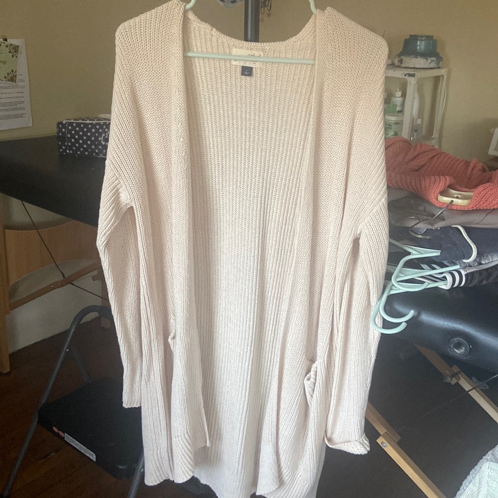 Cream open face pocketed sweater